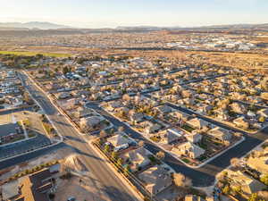 Aerial overview of property's location featuring nearby suburban area and a mountainous background