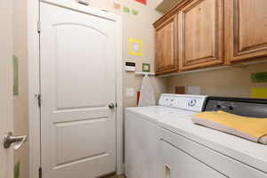 Laundry room featuring washer and dryer and cabinet space