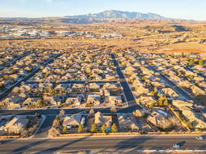 Aerial view of property's location with nearby suburban area and a mountainous background