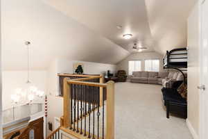 Interior space featuring light colored carpet and a chandelier