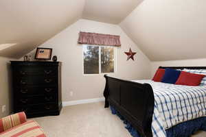 Bedroom with light carpet and baseboards