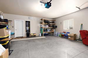Garage with a garage door opener and secured water heater