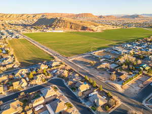 Aerial overview of property's location with a mountain backdrop, nearby suburban area, and rural landscape