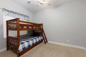 Bedroom featuring light colored carpet and ceiling fan