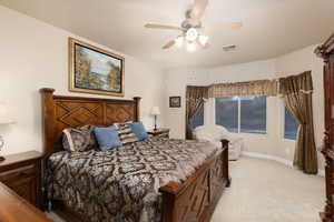 Bedroom featuring light carpet and ceiling fan