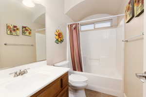 Full bathroom featuring vanity, shower / bathtub combination with curtain, and tile patterned floors