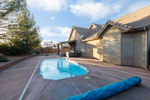 View of pool featuring a fenced backyard and patio surround