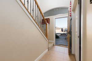 Entrance foyer featuring light tile patterned flooring and baseboards