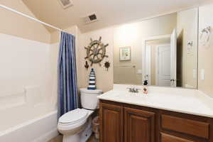 Full bathroom with shower / bath combination with curtain and vanity