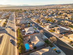 Aerial overview of property's location featuring mountains and nearby suburban area
