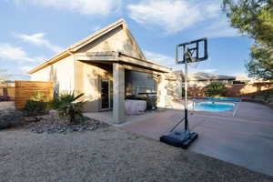 Rear view of house featuring a patio area, a fenced backyard, and stucco siding