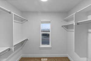 Walk in closet featuring carpet flooring