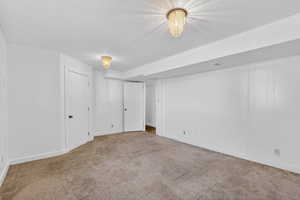 Unfurnished bedroom with a textured ceiling and light carpet
