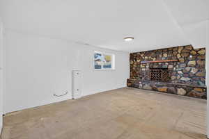 Unfurnished living room featuring baseboards and a fireplace