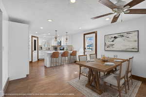 Dining area featuring light wood-style flooring, a textured ceiling, recessed lighting, and ceiling fan