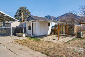 Rear view of property with a gate, a metal roof, and a mountain view