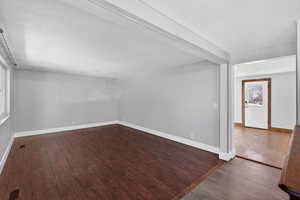 Unfurnished room with dark wood finished floors