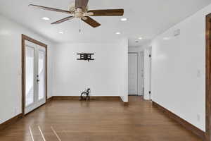 Unfurnished room featuring hardwood / wood-style flooring, ceiling fan, and recessed lighting