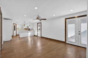Unfurnished living room featuring recessed lighting, french doors, dark wood-style flooring, ceiling fan, and a textured ceiling