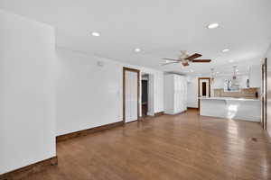 Unfurnished living room with dark wood finished floors, recessed lighting, a ceiling fan, and a textured ceiling