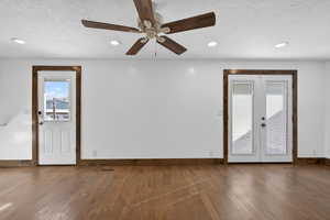 Unfurnished room with french doors, a textured ceiling, hardwood / wood-style floors, recessed lighting, and ceiling fan