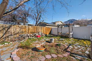 Fenced backyard with a mountain view
