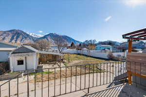 Fenced backyard with an outbuilding and a mountain view