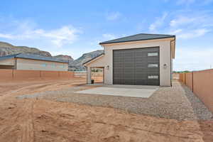 Garage featuring a mountain view and driveway