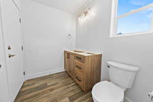 Bathroom with wood tiled floors and vanity