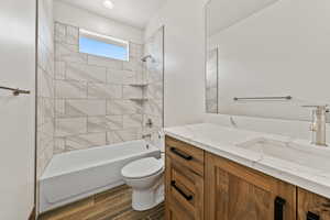 Bathroom with vanity, bathtub / shower combination, and dark wood finished floors