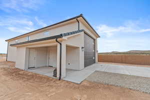 Garage featuring concrete driveway