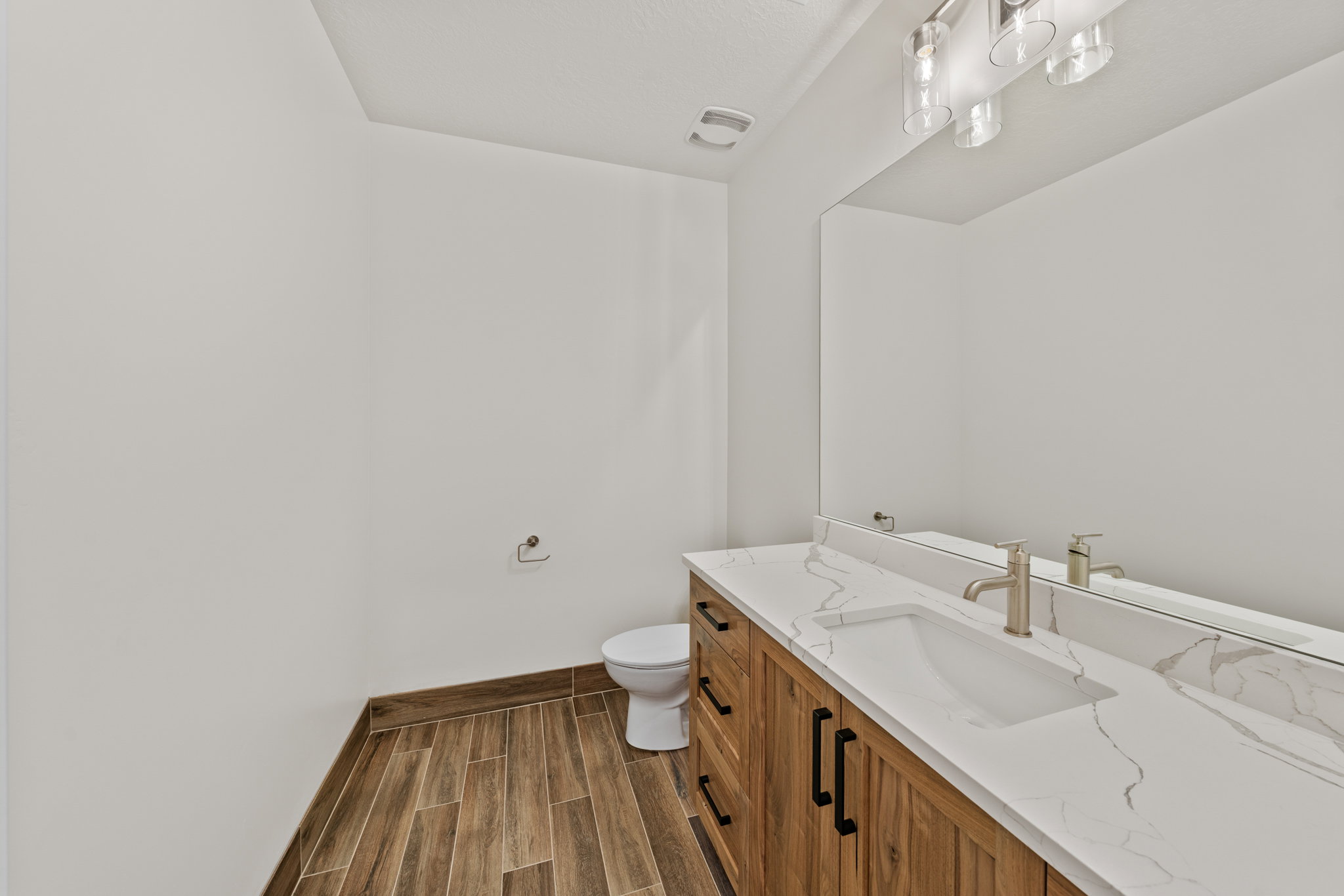 Bathroom featuring vanity and wood finish floors