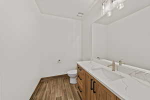 Bathroom featuring vanity and wood finish floors