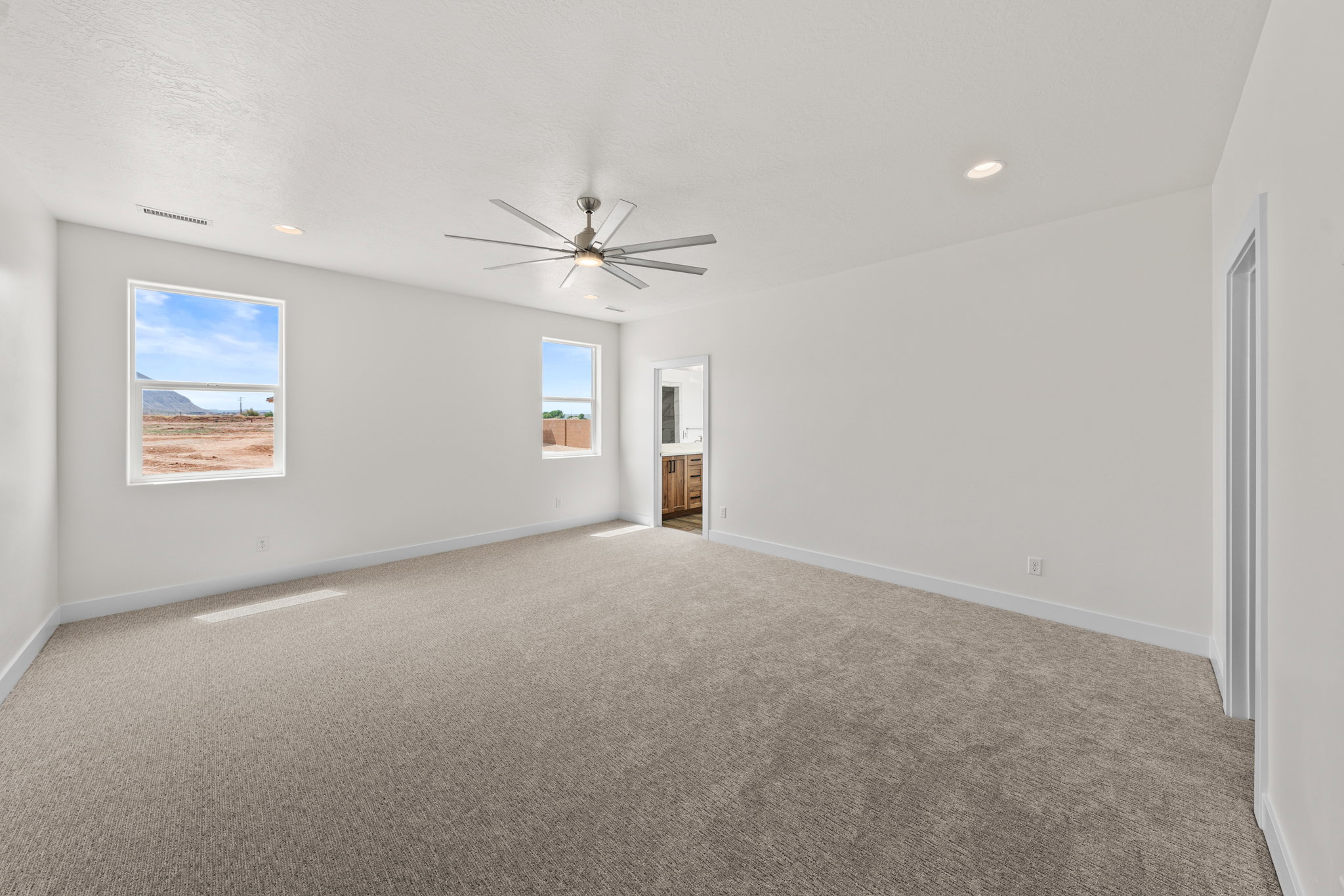 Spare room featuring light carpet, recessed lighting, and ceiling fan