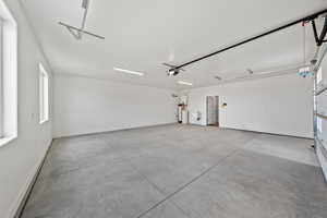 Garage featuring a sink and baseboards