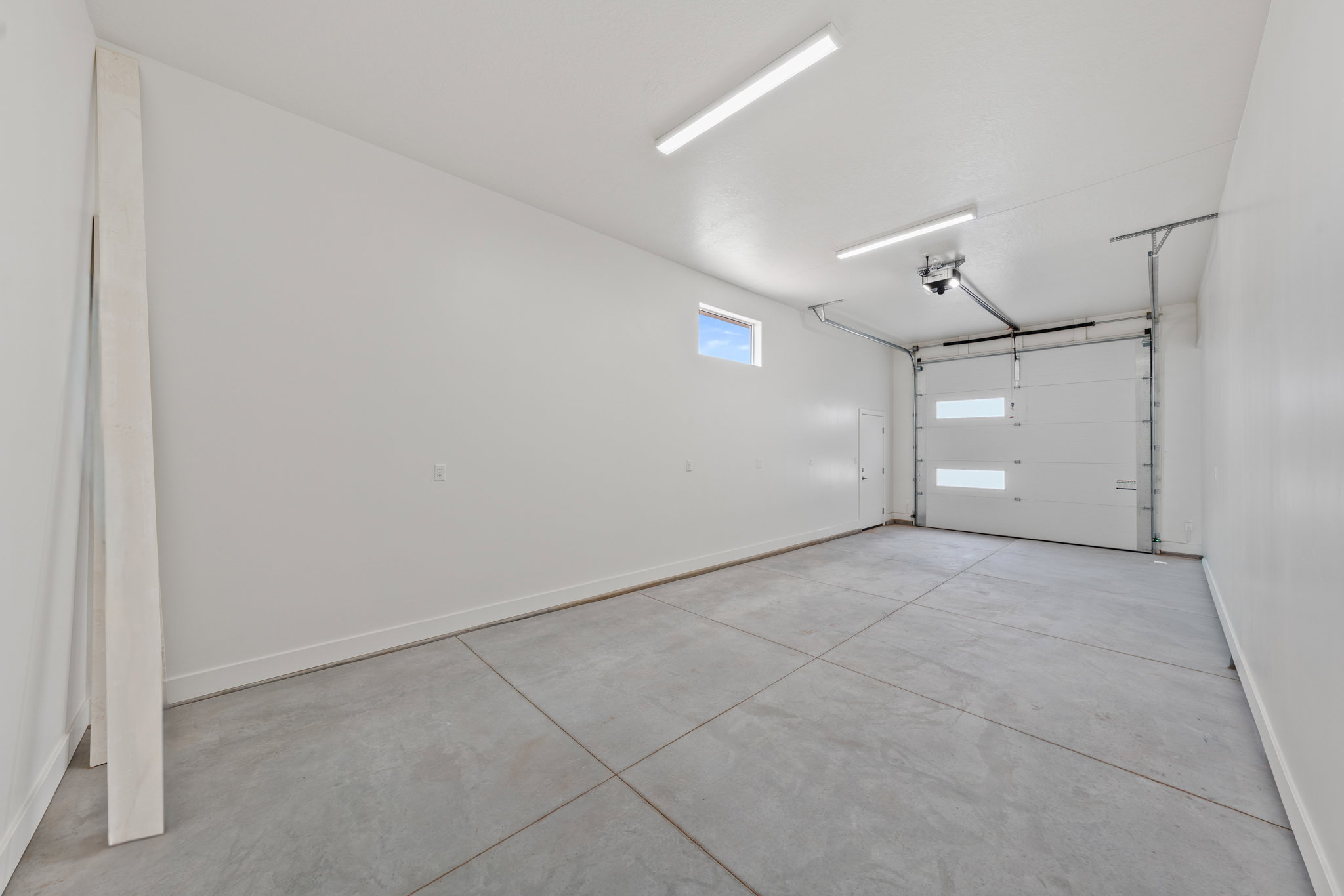 Garage featuring baseboards