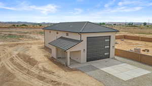 View of front of property featuring stucco siding, a tiled roof, driveway, and a mountain view