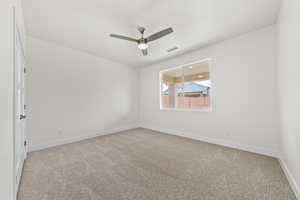 Unfurnished room featuring light carpet and a ceiling fan