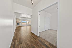 Corridor with wood finish floors and baseboards