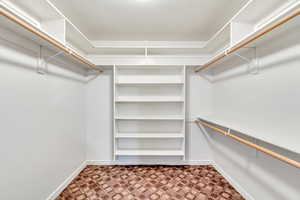 Walk in closet with light carpet