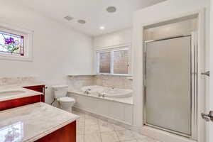Full bath featuring a stall shower, vanity, a garden tub, light tile patterned floors, and recessed lighting