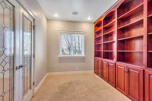 Unfurnished office with light carpet and baseboards