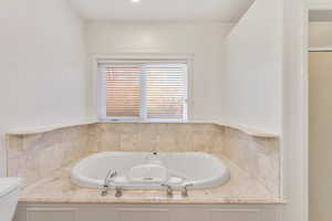 Bathroom with toilet and a bath