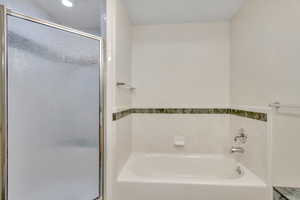 Full bath with a garden tub and a shower stall
