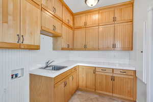 Laundry room with hookup for a washing machine and cabinet space