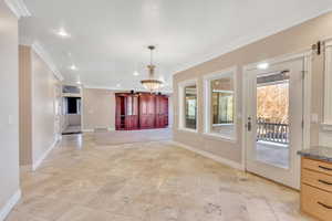 Unfurnished dining area with crown molding and recessed lighting