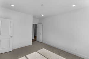 Unfurnished bedroom with carpet and recessed lighting