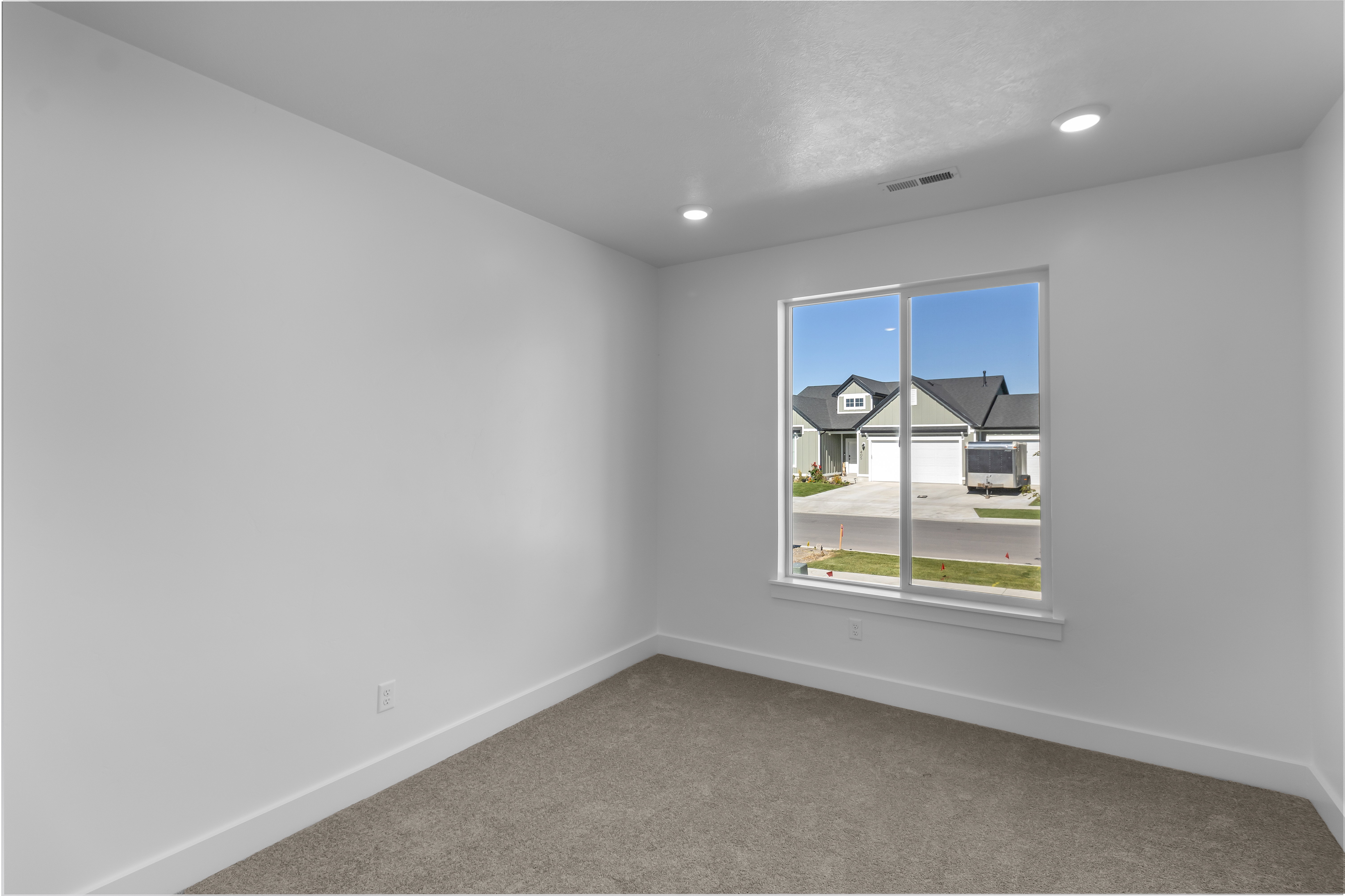 Carpeted spare room featuring baseboards and recessed lighting