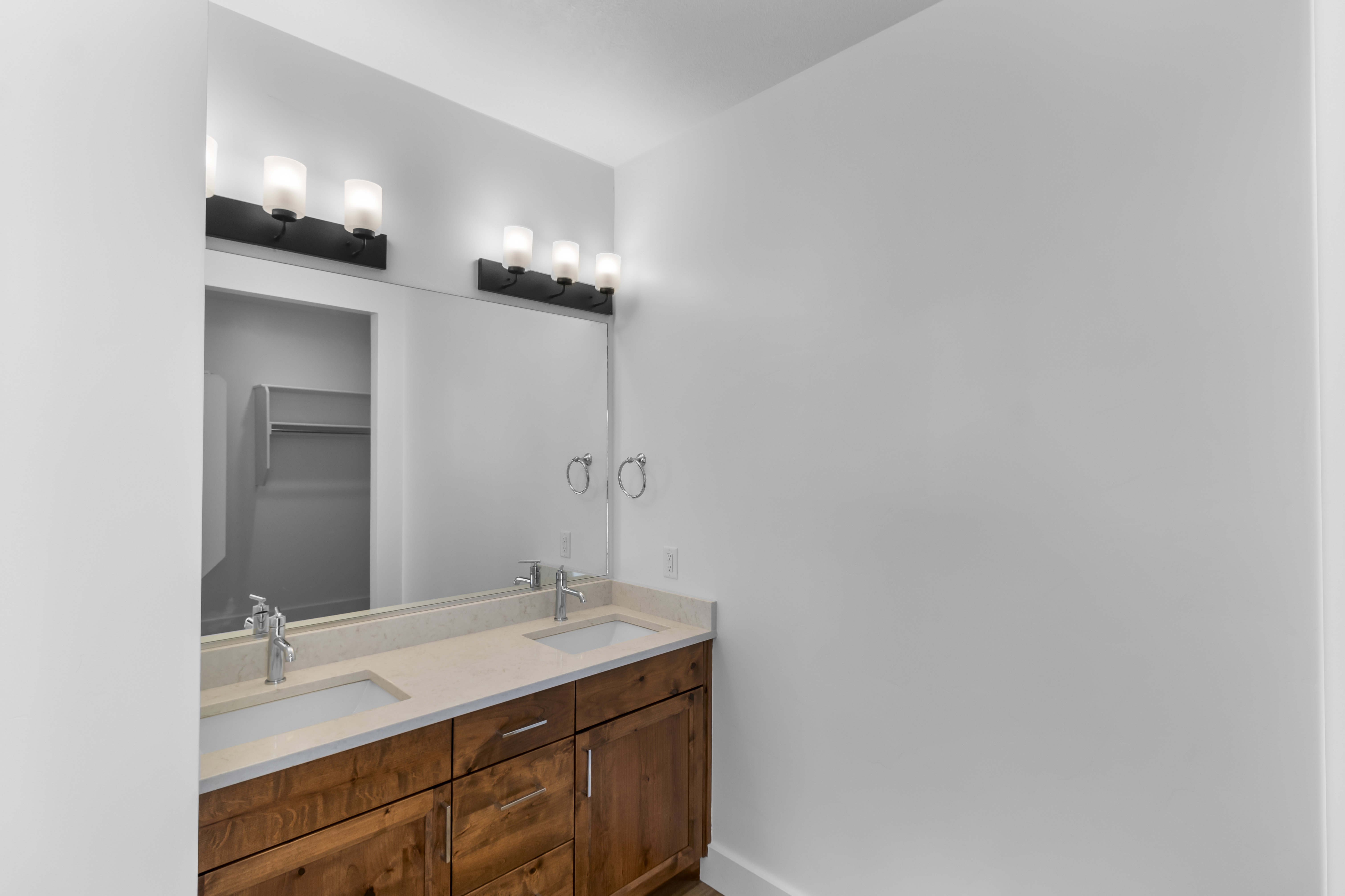 Bathroom with double vanity and a spacious closet