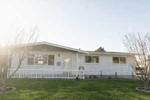 View of front of property with brick siding and a front yard